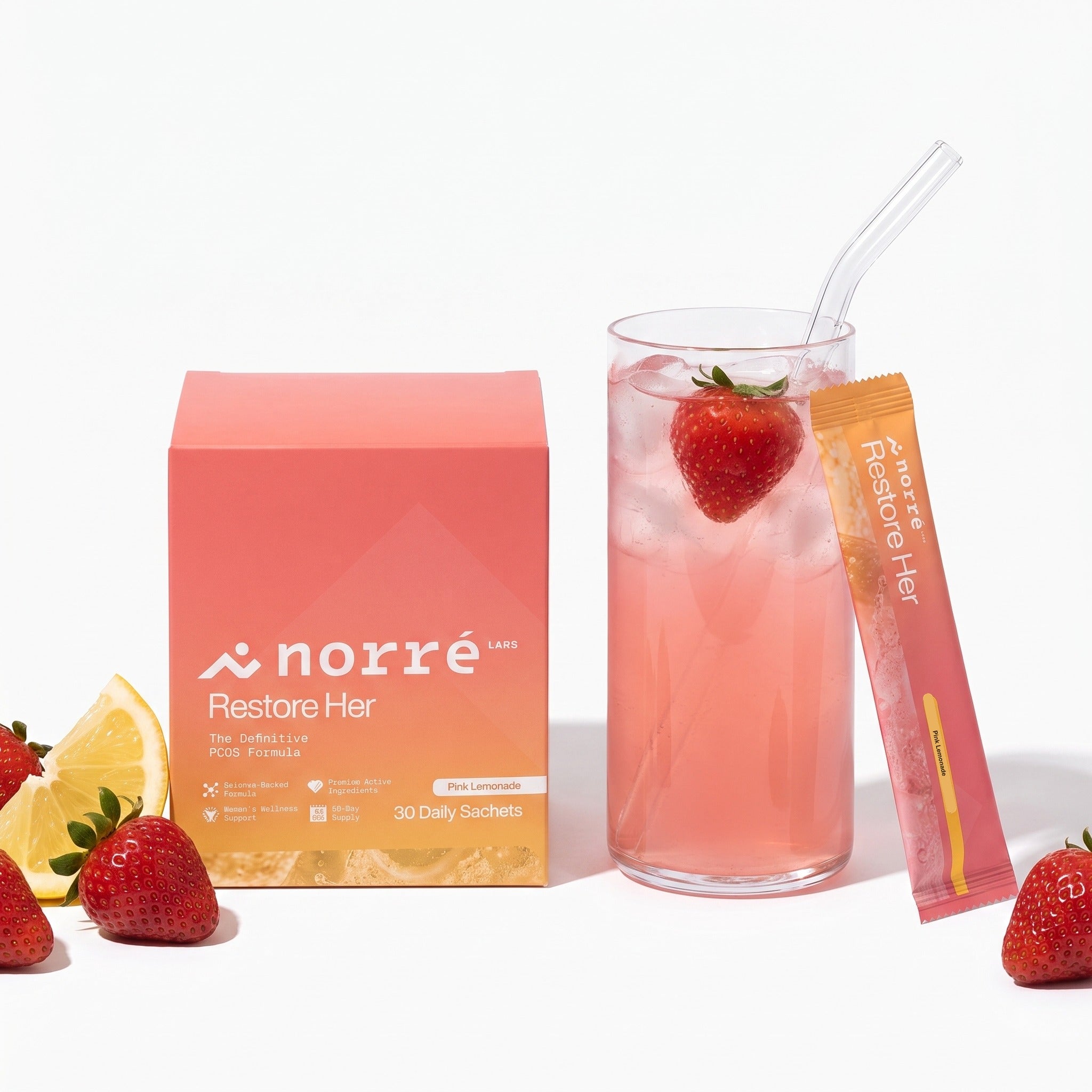 Norré RestoreHer box, sachet and glass of pink lemonade with strawberries